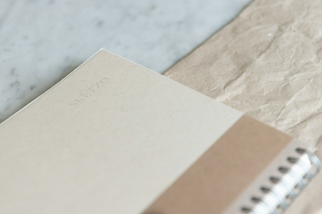 Notebook and pen on a desk ready for writing a message
